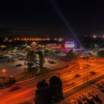 Nighttime view of a busy city intersection.